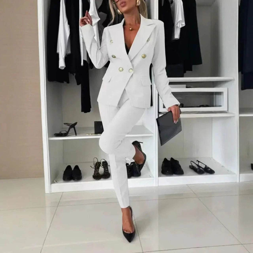 Woman in a chic white suit with gold buttons, holding a clutch in a modern wardrobe setting, ZA-Zola fashion