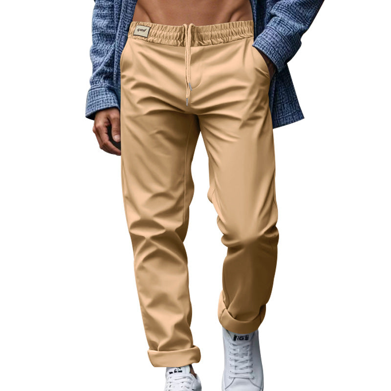 Beige pants worn by a person with a blue jacket on a white background