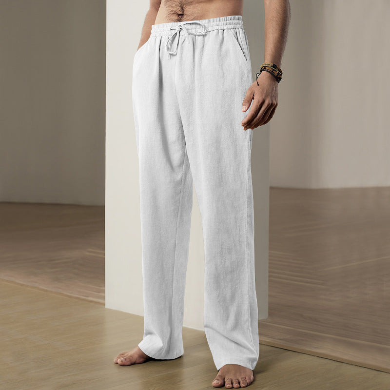 Person wearing white linen pants in a minimalistic setting