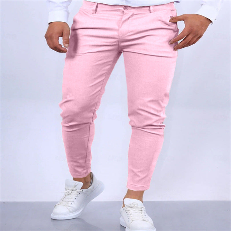Pink pants worn by a person on a light gray background