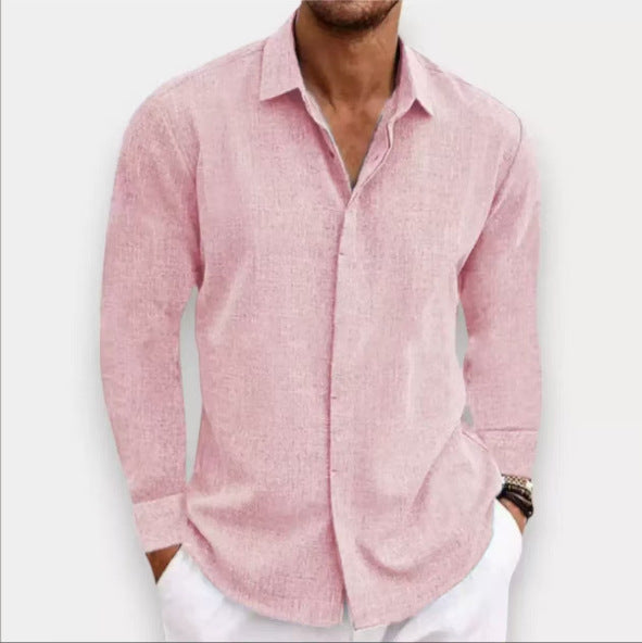 Man wearing a pink button-up shirt with rolled-up sleeves against a white background