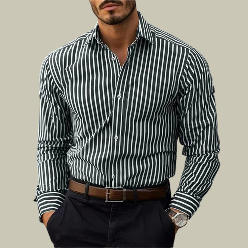 Man wearing a black and white striped shirt with a beige background