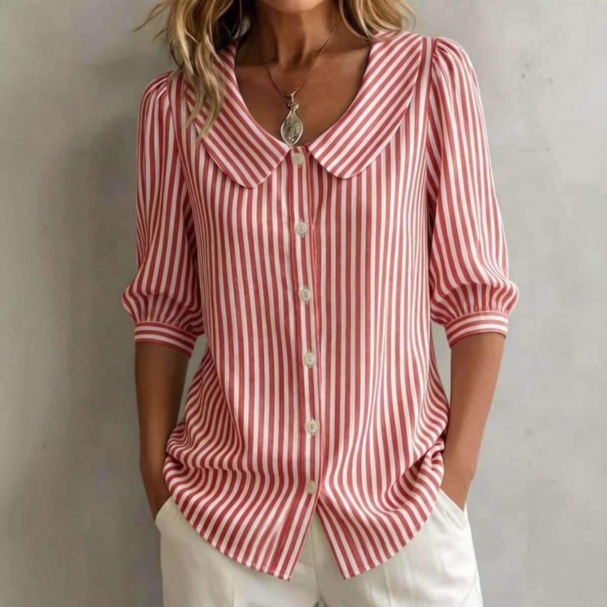 Red and white striped shirt worn by a person against a plain background