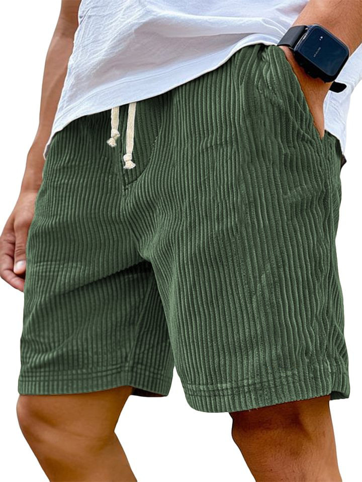 Green shorts worn by a person on a white background