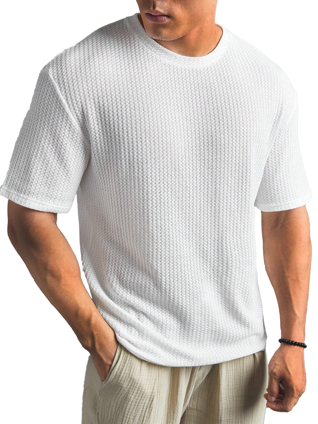 Person wearing a textured white t-shirt on a white background