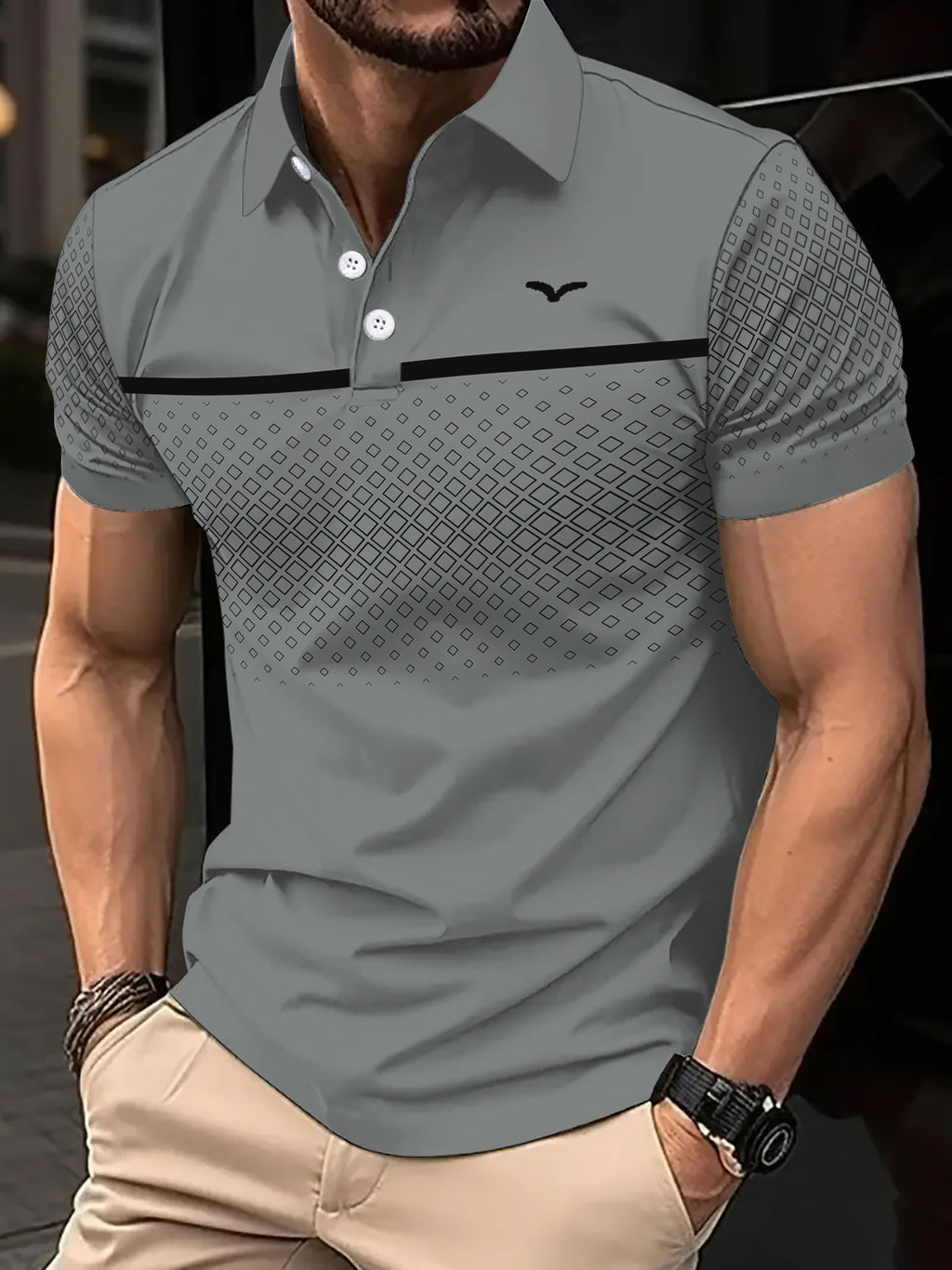 Man wearing a gray patterned polo shirt with a blurred background