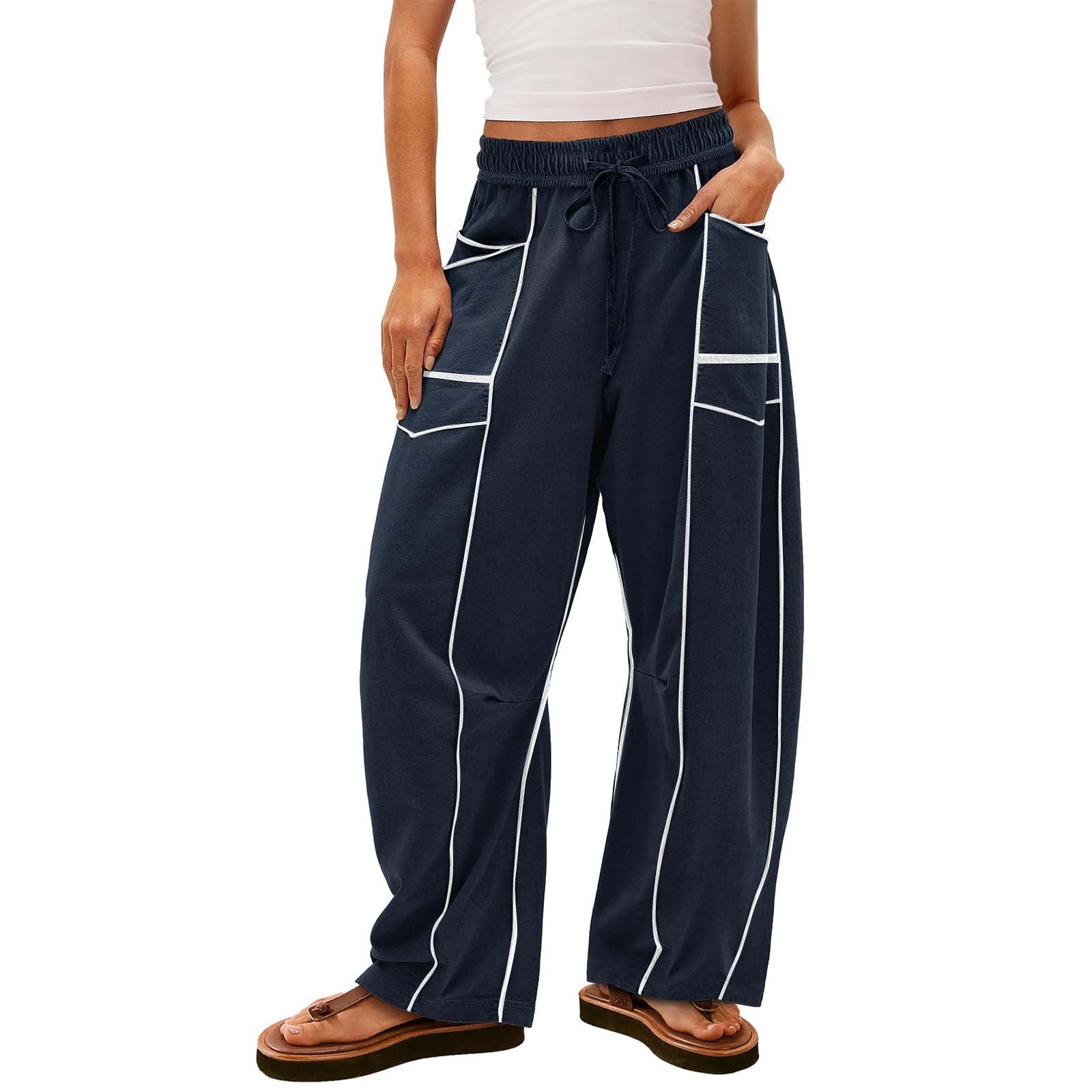 Navy blue pants with white piping worn by a person on a white background