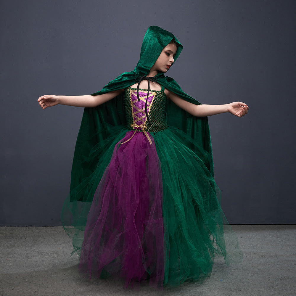 Child in a green and purple costume against a gray background