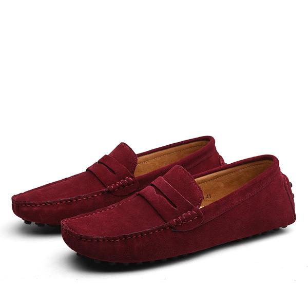Pair of red loafers on a white background