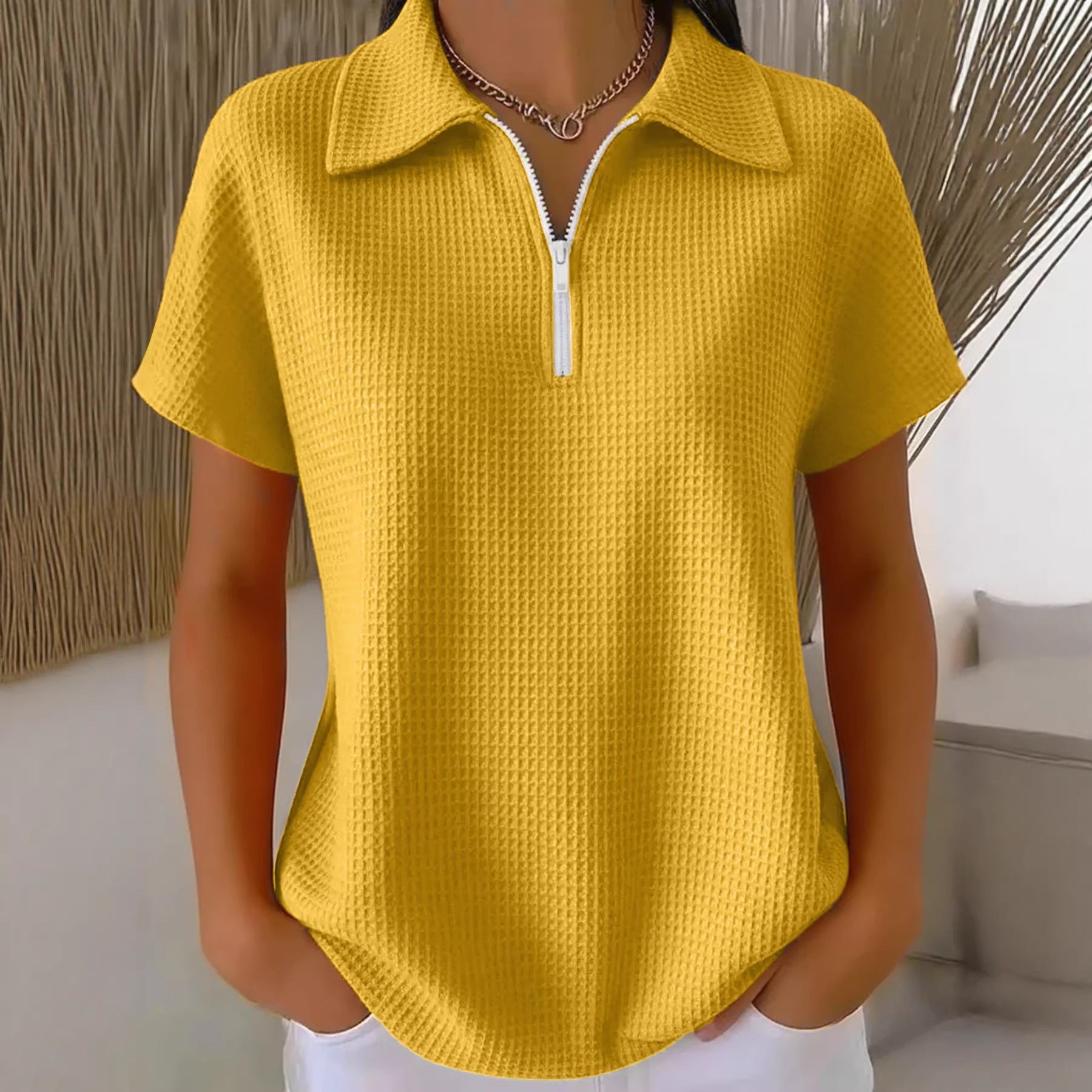 Yellow textured short-sleeve shirt worn by a mannequin against a neutral background