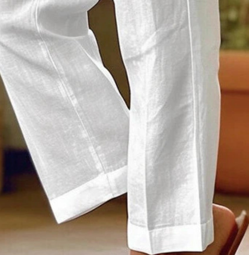 White pants being worn, with a blurred background
