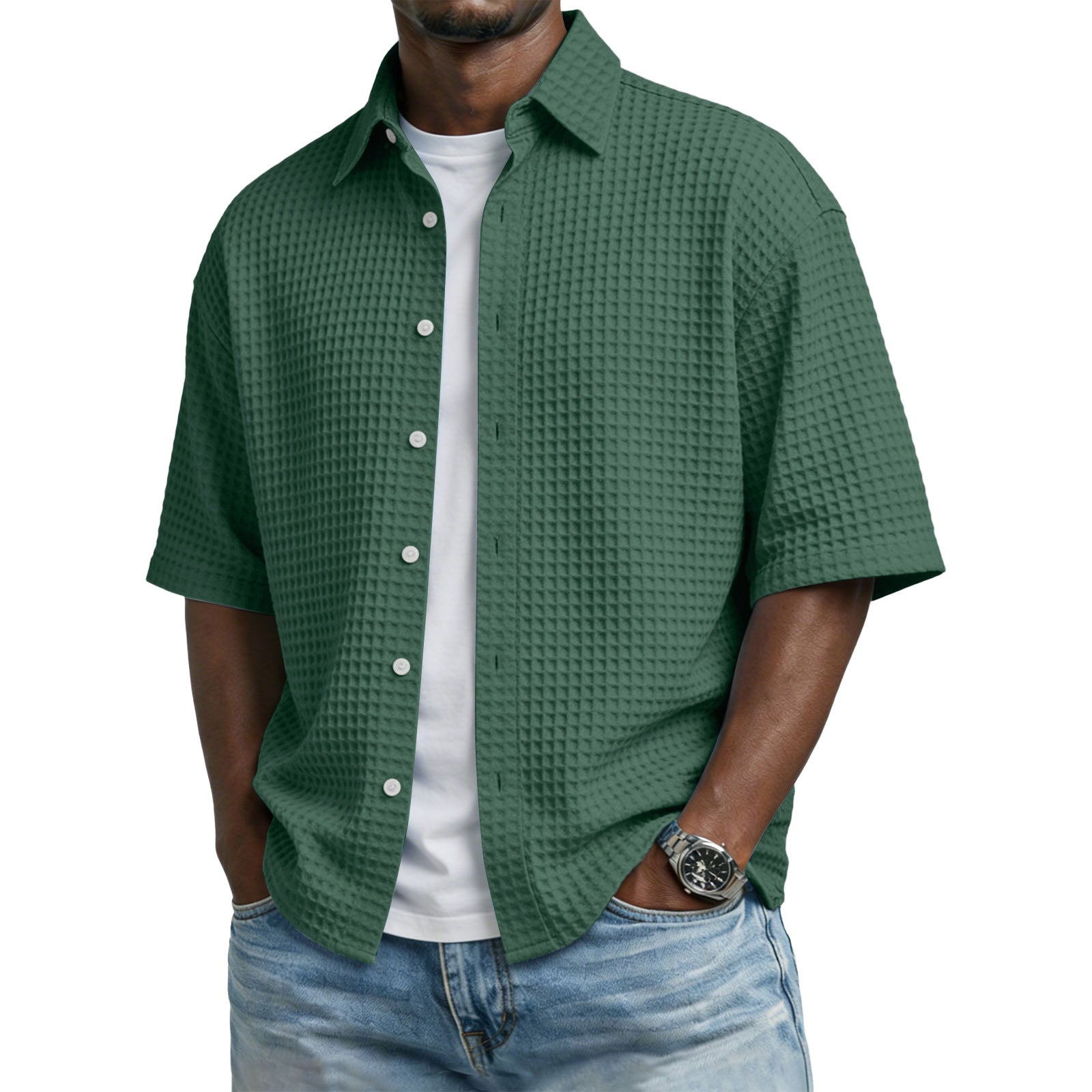 Man wearing a green textured shirt over a white shirt with blue jeans on a white background