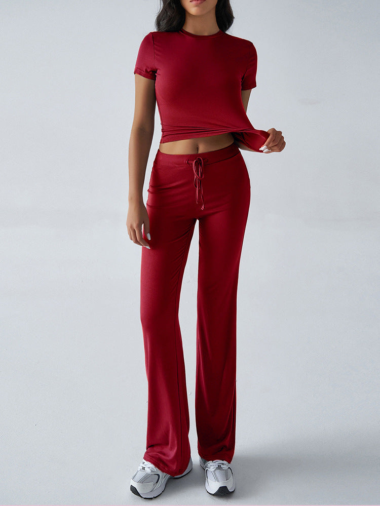 Person wearing a red outfit with a matching top and pants on a white background