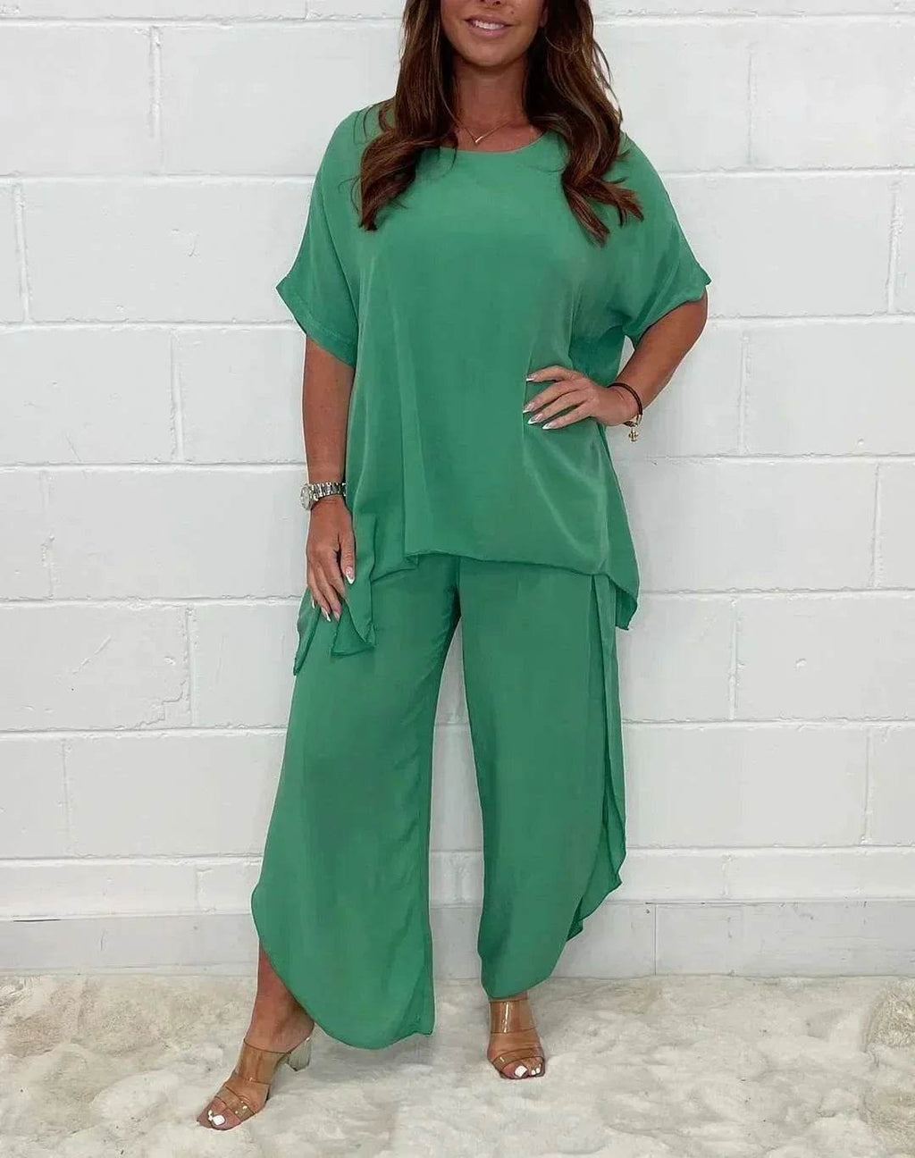 Woman wearing loose green two-piece set from ZA-Zola, stylish outfit against white wall