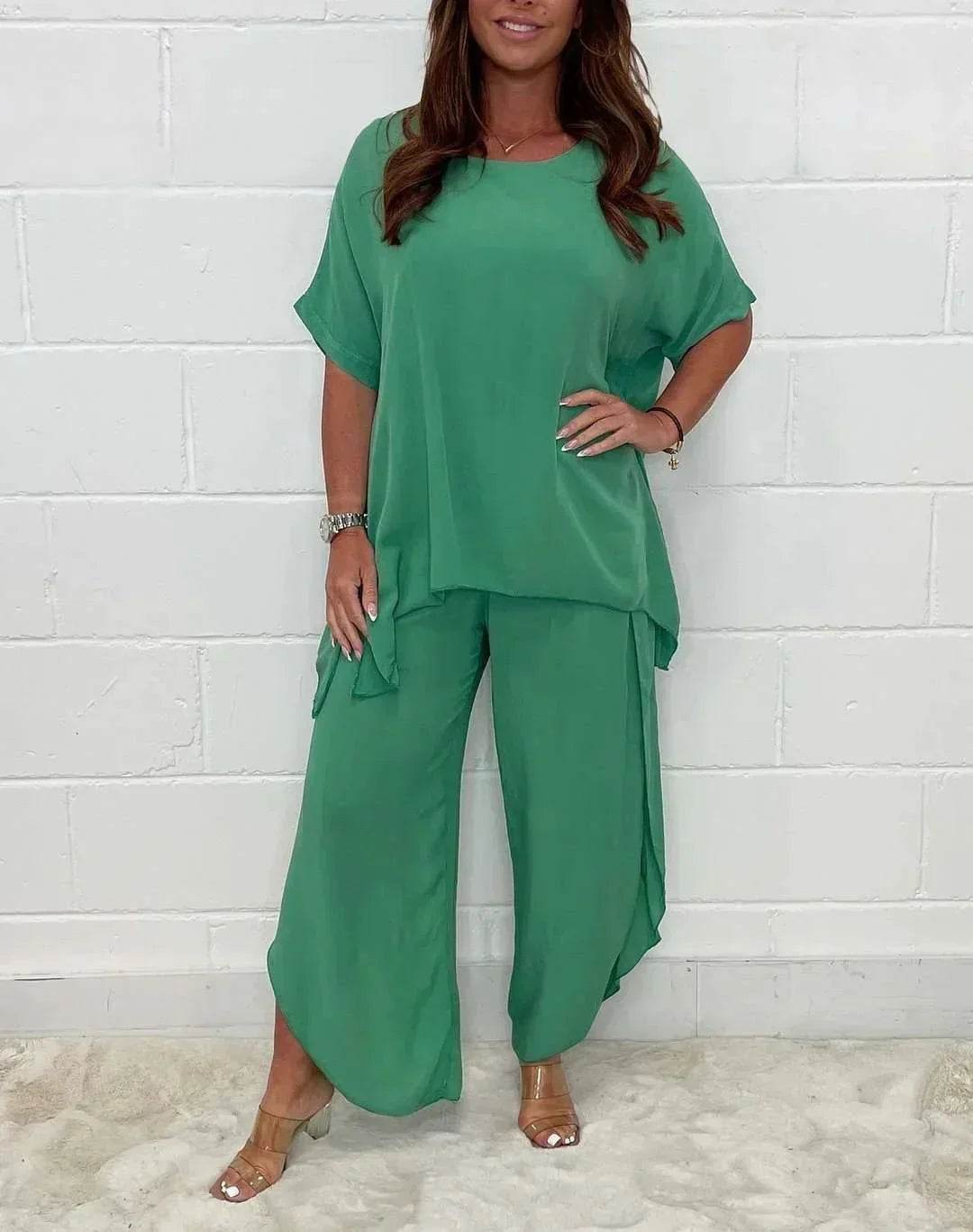 Woman wearing loose green two-piece set from ZA-Zola, stylish outfit against white wall