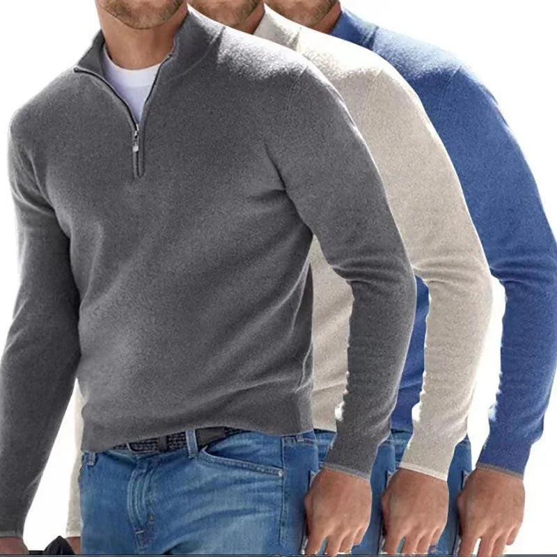 Three men wearing quarter-zip sweaters in gray, white, and blue.