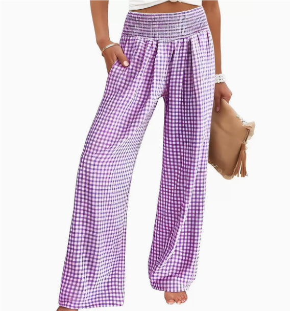 Purple and white checkered pants worn by a person on a white background