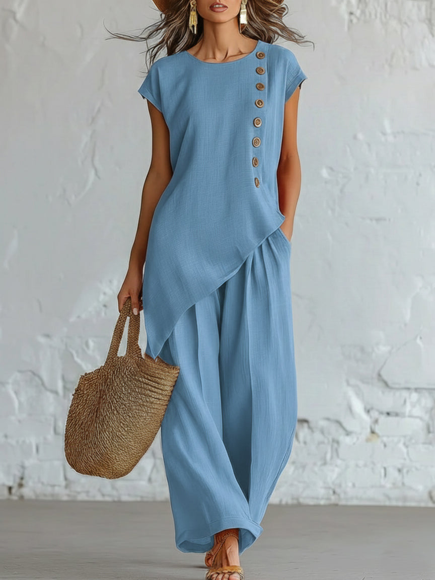Woman wearing a blue dress with a white textured wall background
