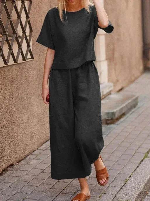 Woman in black wide-leg pants and loose top, street style fashion ZA-Zola United Kingdom