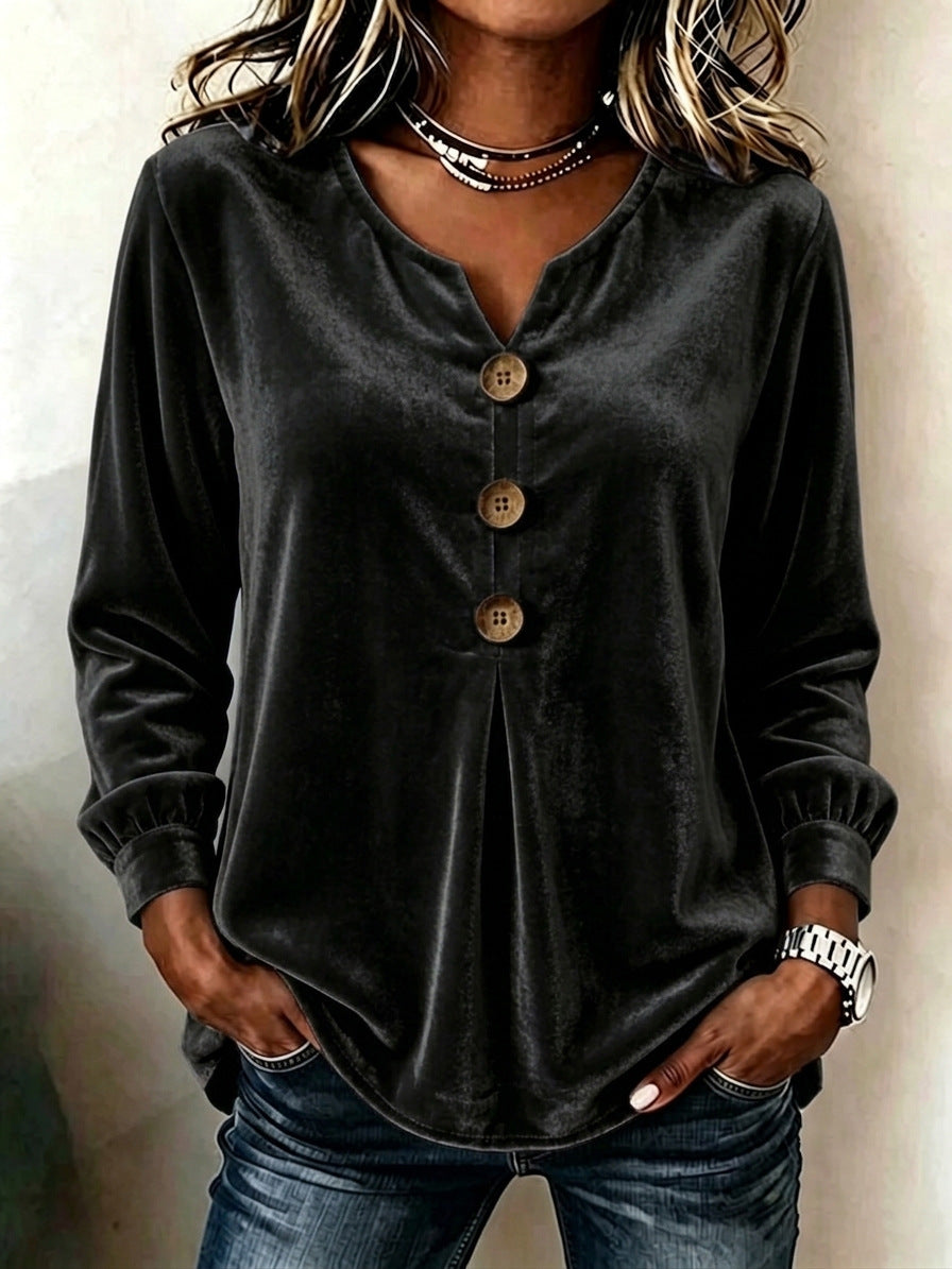 Person wearing a black long-sleeve button-up shirt and jeans against a neutral background