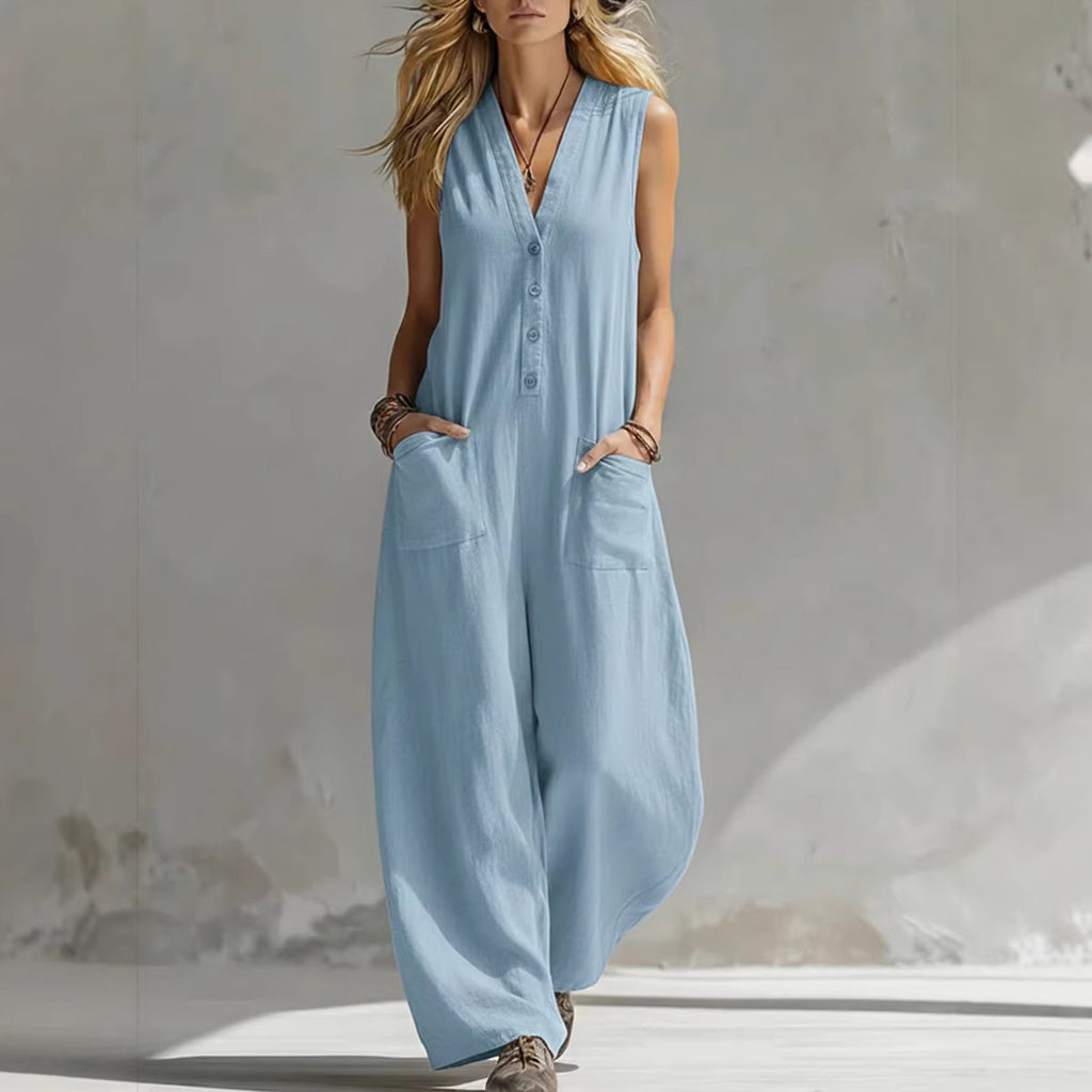 Woman wearing a light blue sleeveless jumpsuit against a neutral background