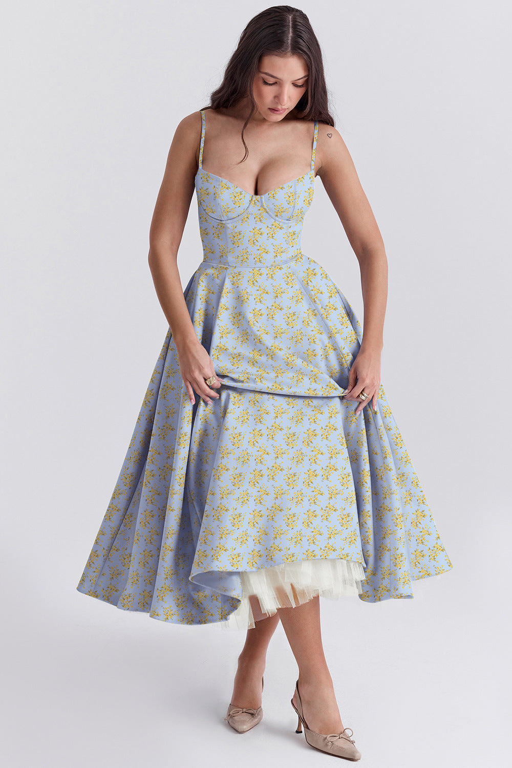 Woman wearing a blue floral dress on a white background