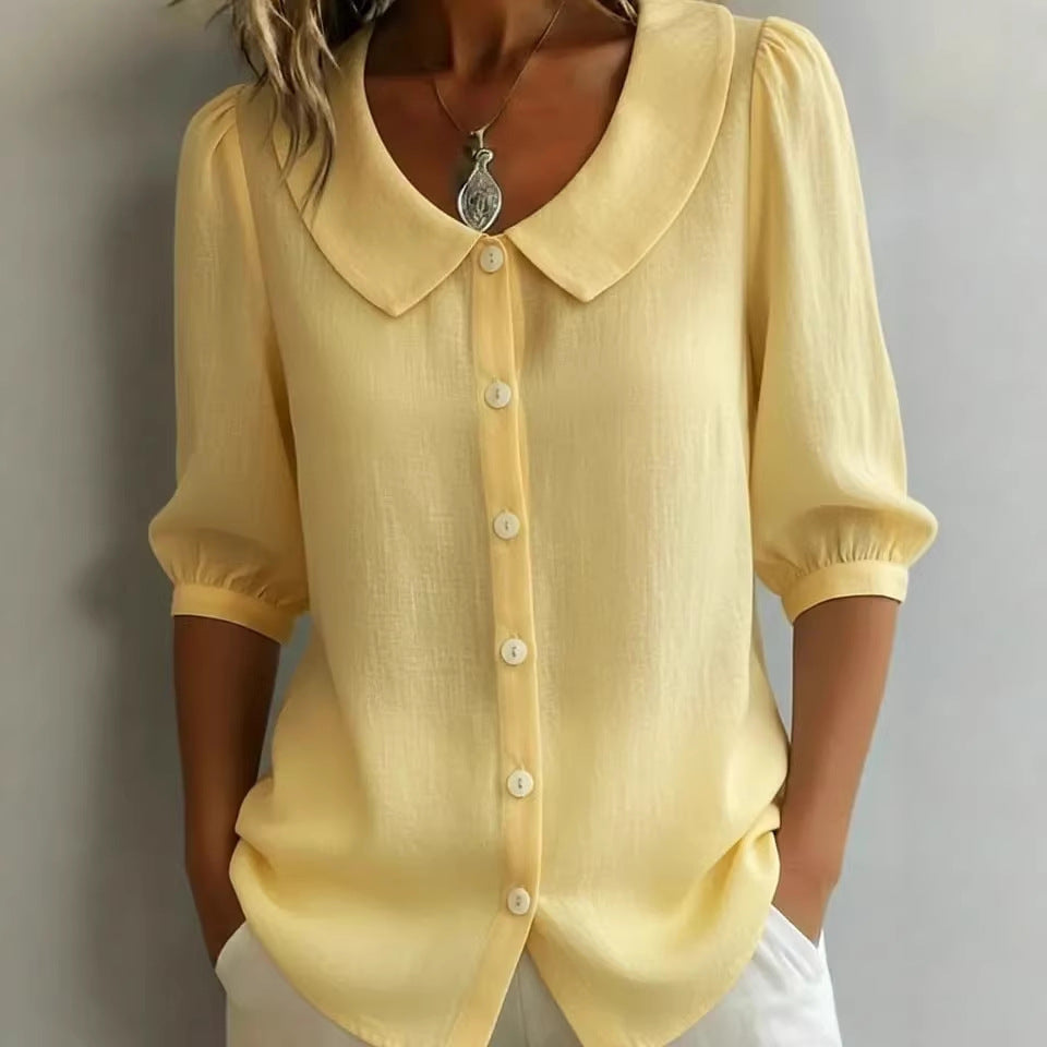 Yellow blouse with a collar and buttons on a gray background