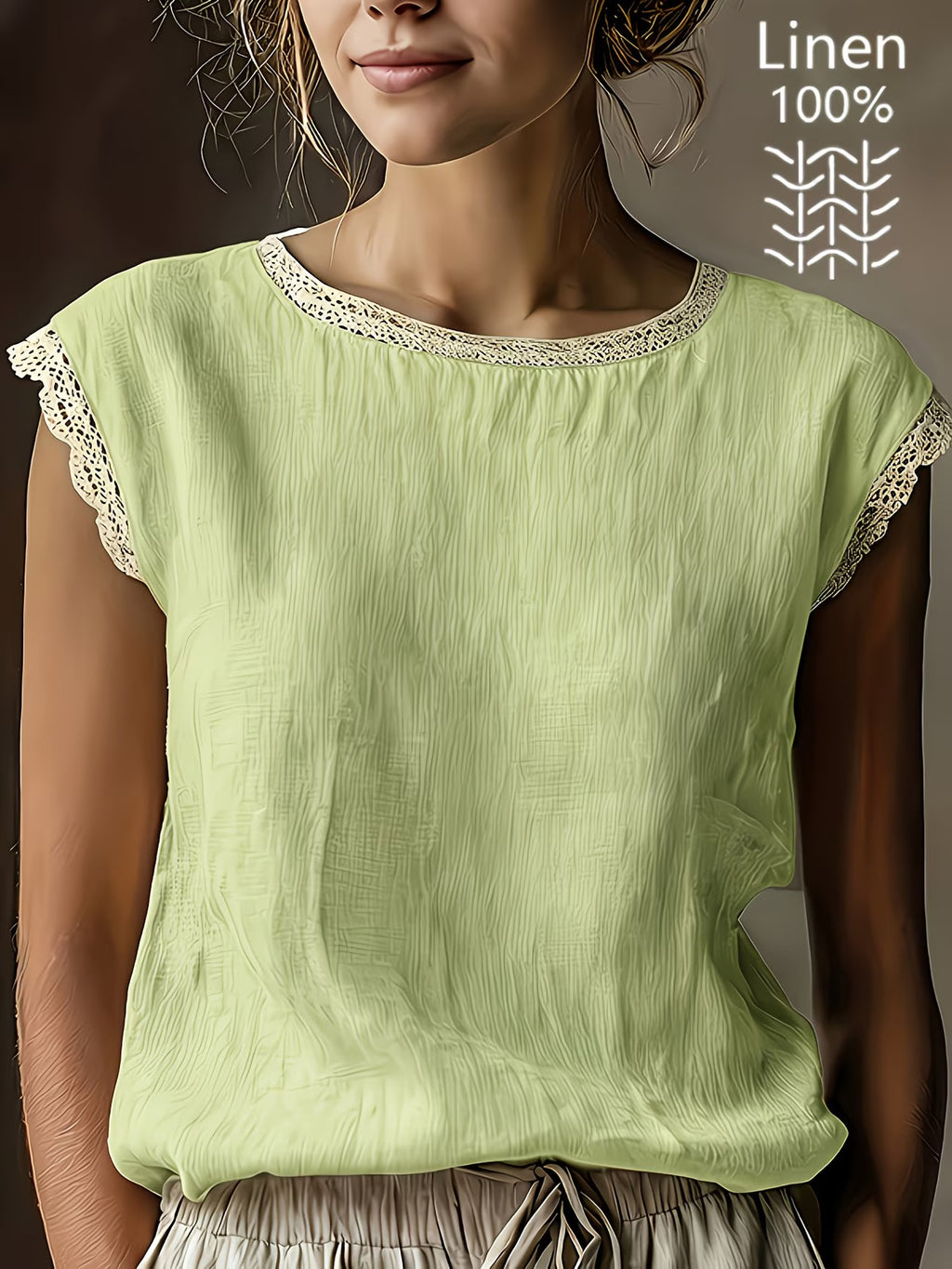Woman wearing a light green linen top with lace trim on a neutral background