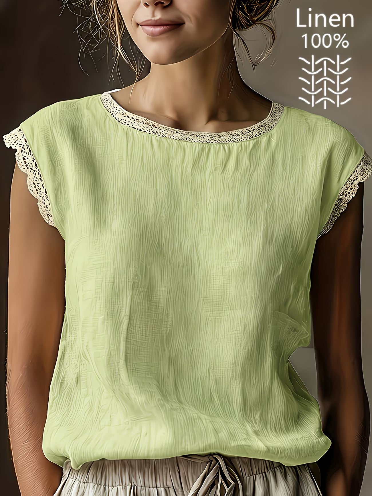 Woman wearing a light green linen top with lace trim on a neutral background