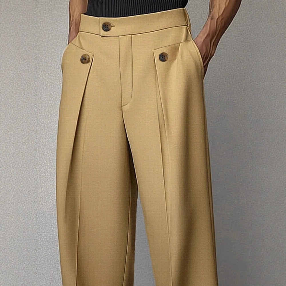 Beige pants with button details on a gray background