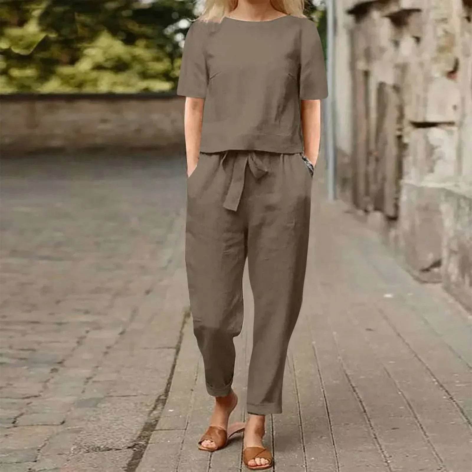 Woman wearing a brown casual linen two-piece set from ZA-Zola on a cobblestone path