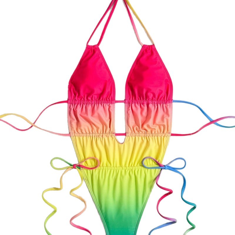 Colorful rainbow-themed swimsuit with pink top and gradient bottom on a white background