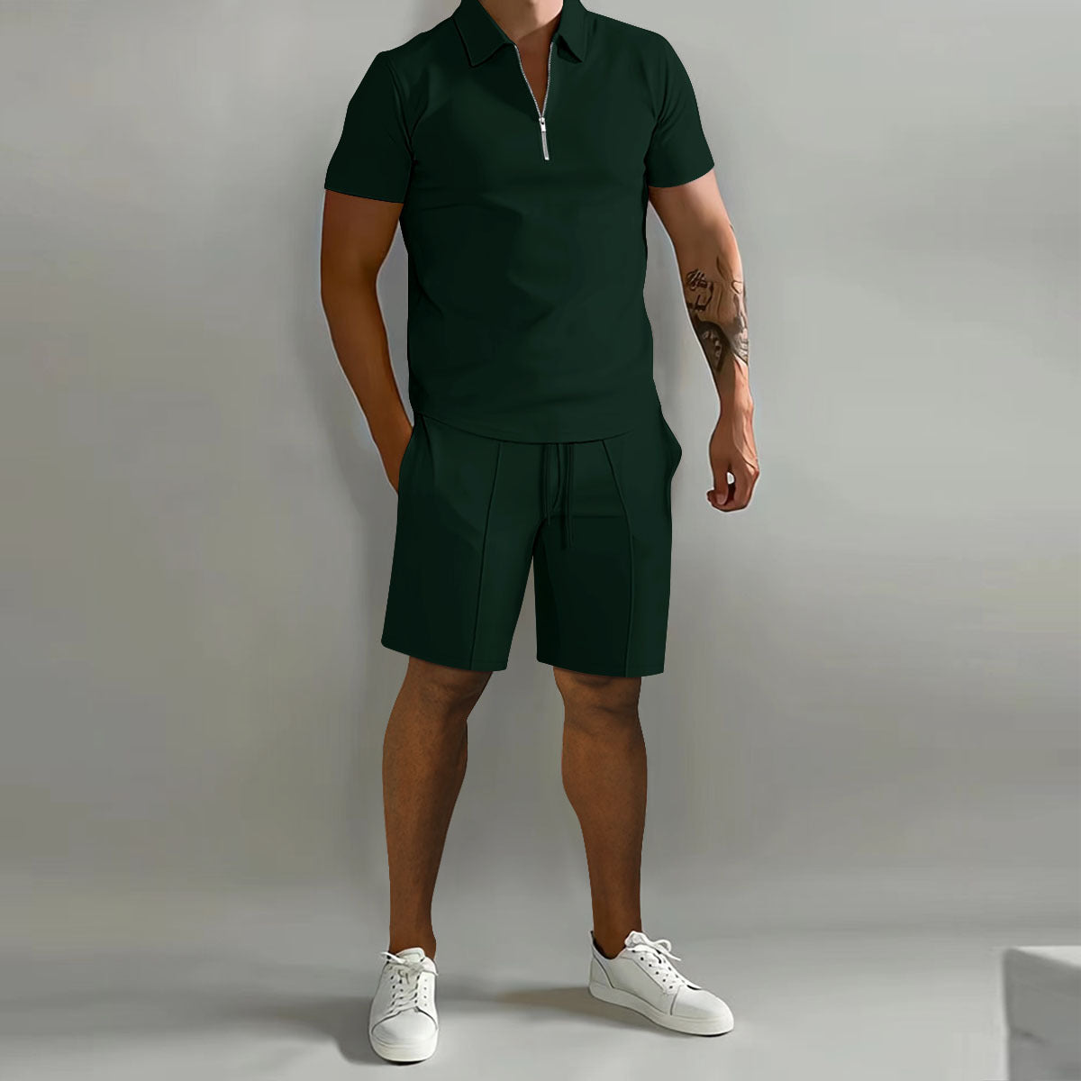 Person wearing a green polo shirt and shorts with white sneakers on a gray background