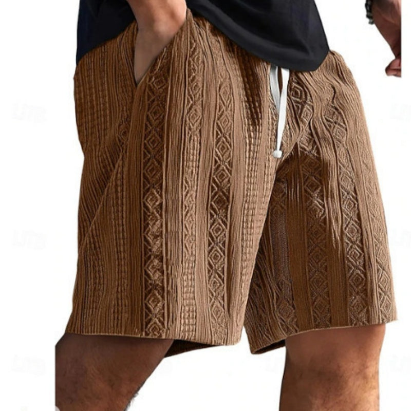 Brown patterned shorts worn by a person on a white background