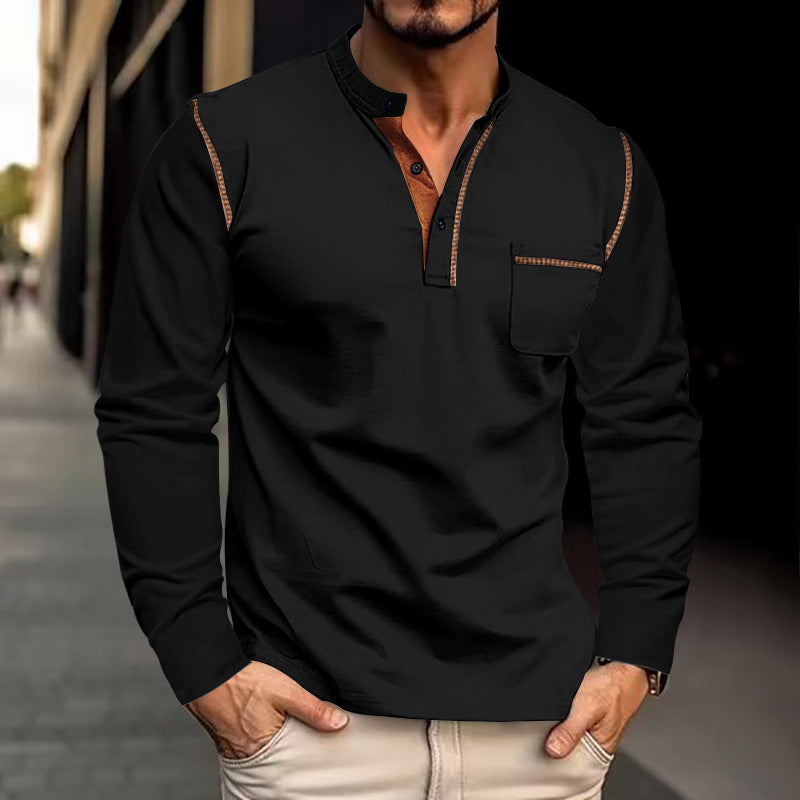 Man wearing a black long-sleeve shirt with brown trim on a blurred street background