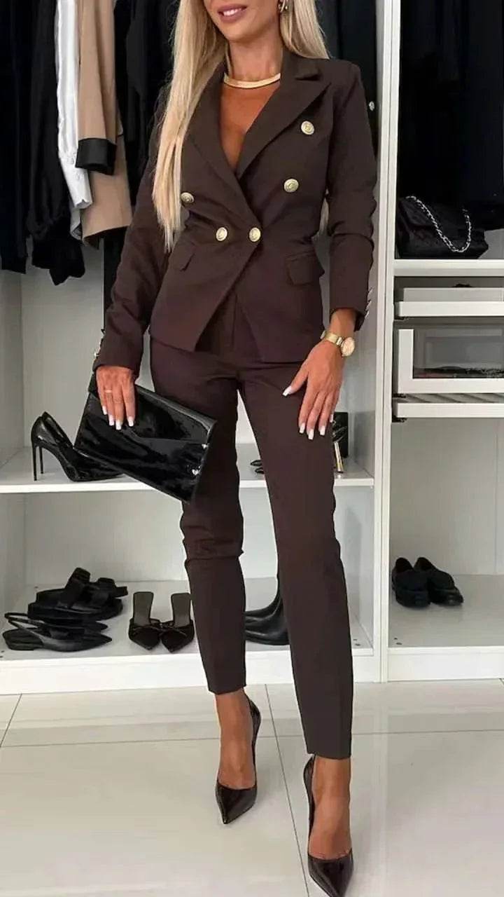 Woman in chic brown tailored suit with gold buttons, black clutch, and heels, ZA-Zola fashion