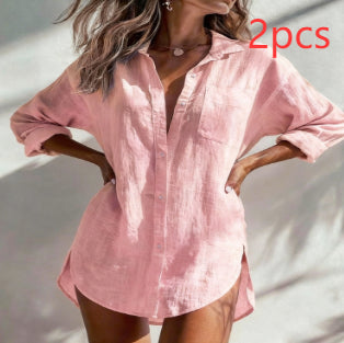 A woman wearing a light pink long-sleeve linen button-up shirt with rolled-up sleeves and a relaxed fit, shown against a sunlit neutral background. Red text in the top right reads '2pcs'.