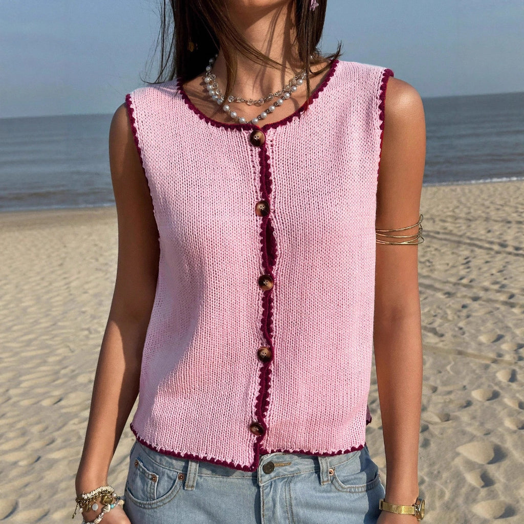 Woman wearing a pink knitted vest on a beach