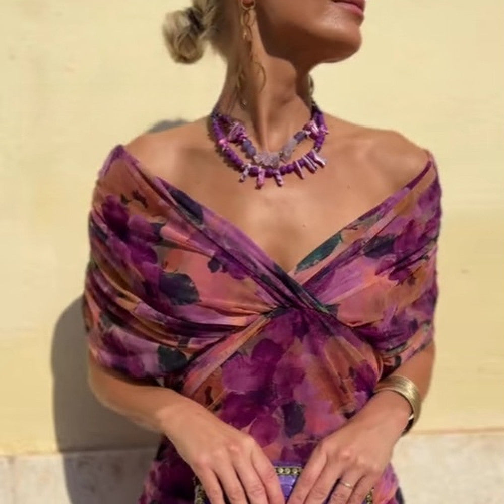 Woman wearing a purple floral dress with a yellow background