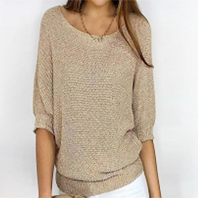 Beige knitted sweater worn by a person on a white background