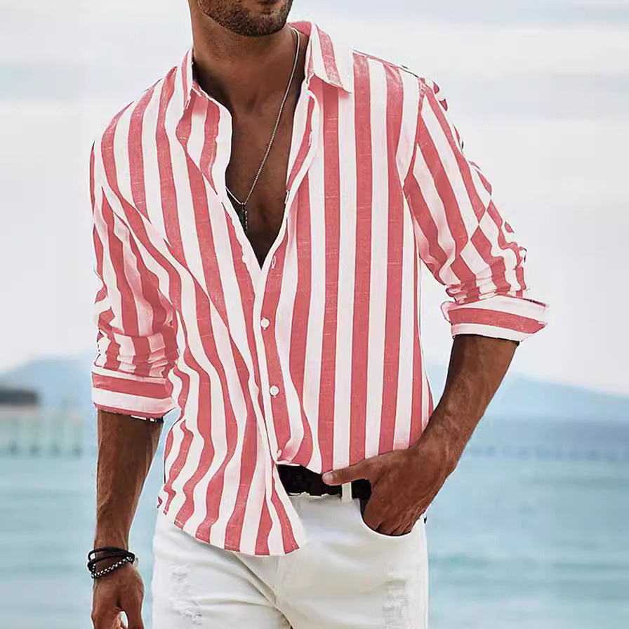 Man wearing a red and white striped shirt with a blurred beach background