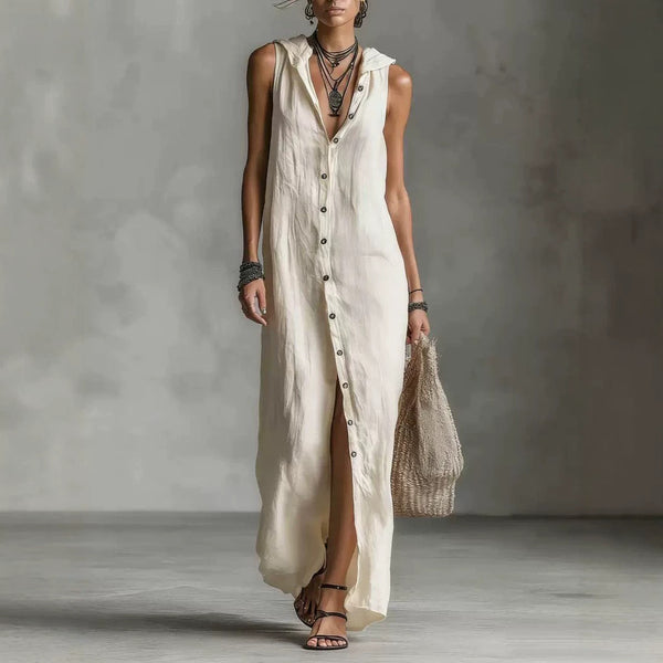 Woman wearing a long beige dress with a neutral background