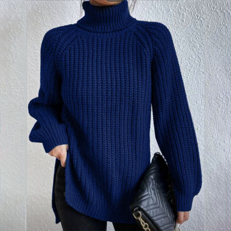 Person wearing a blue knitted sweater against a plain background