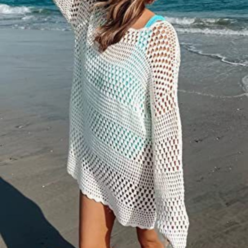 Woman wearing a white crochet cover-up on a beach