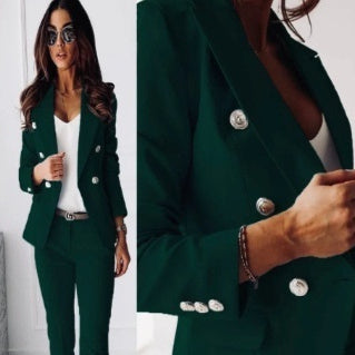Green suit with white buttons worn by a person, close-up of suit jacket.