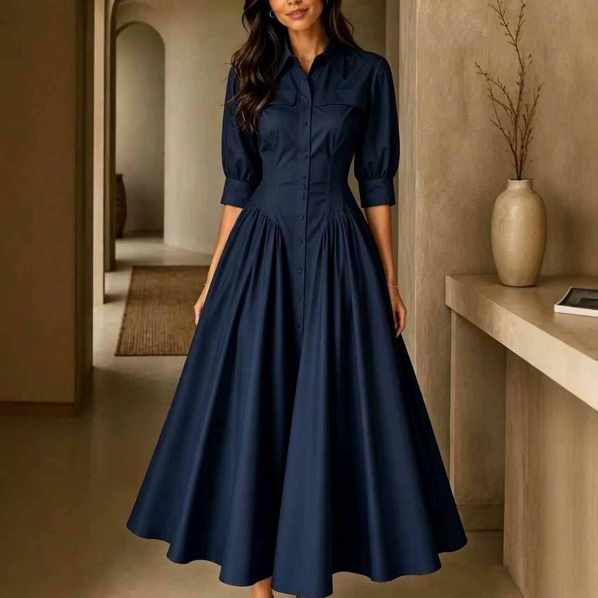 Woman wearing a navy blue dress in an indoor setting