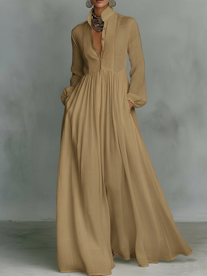 Long beige dress with a textured collar against a gray background