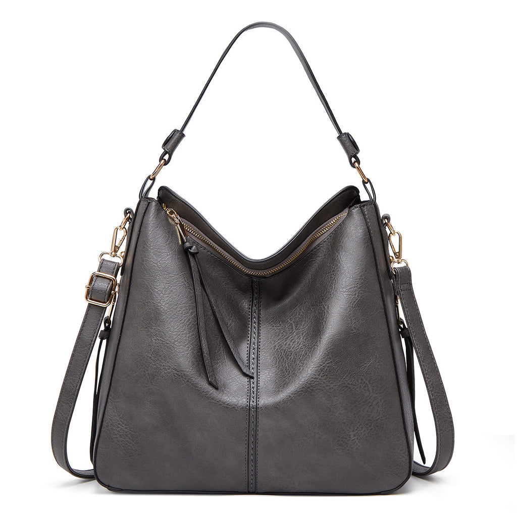 Gray handbag with gold accents on a white background