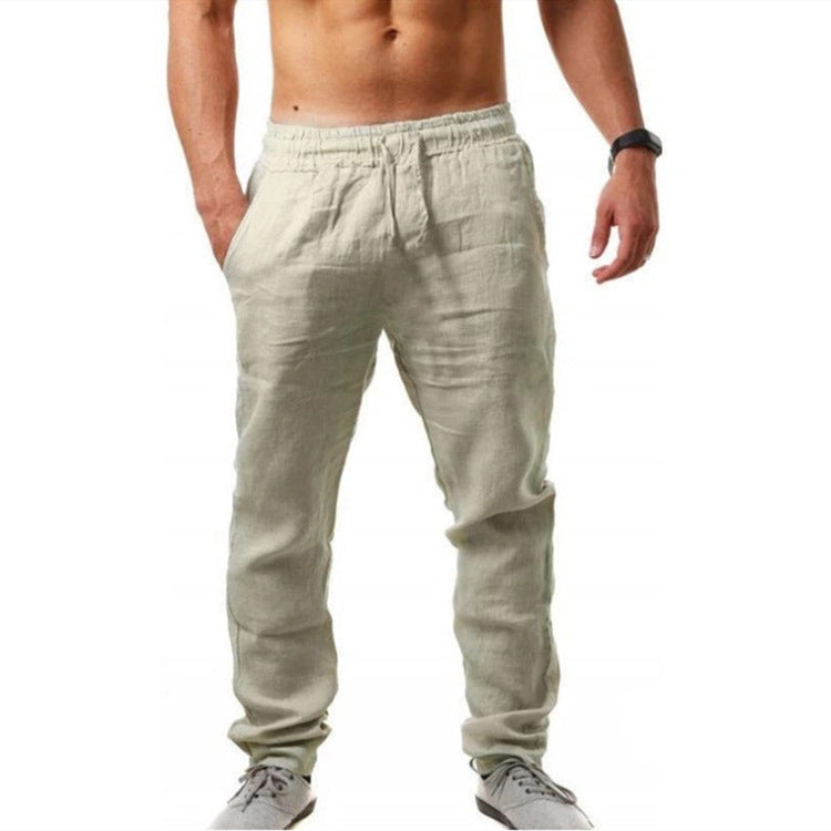 Man wearing light gray jogger pants on a white background