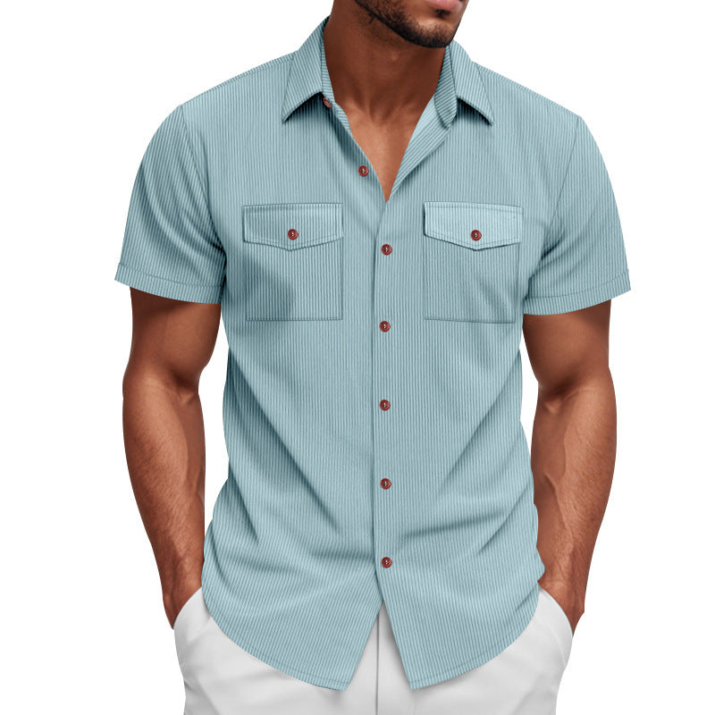 Man wearing a light blue striped shirt with red buttons on a white background